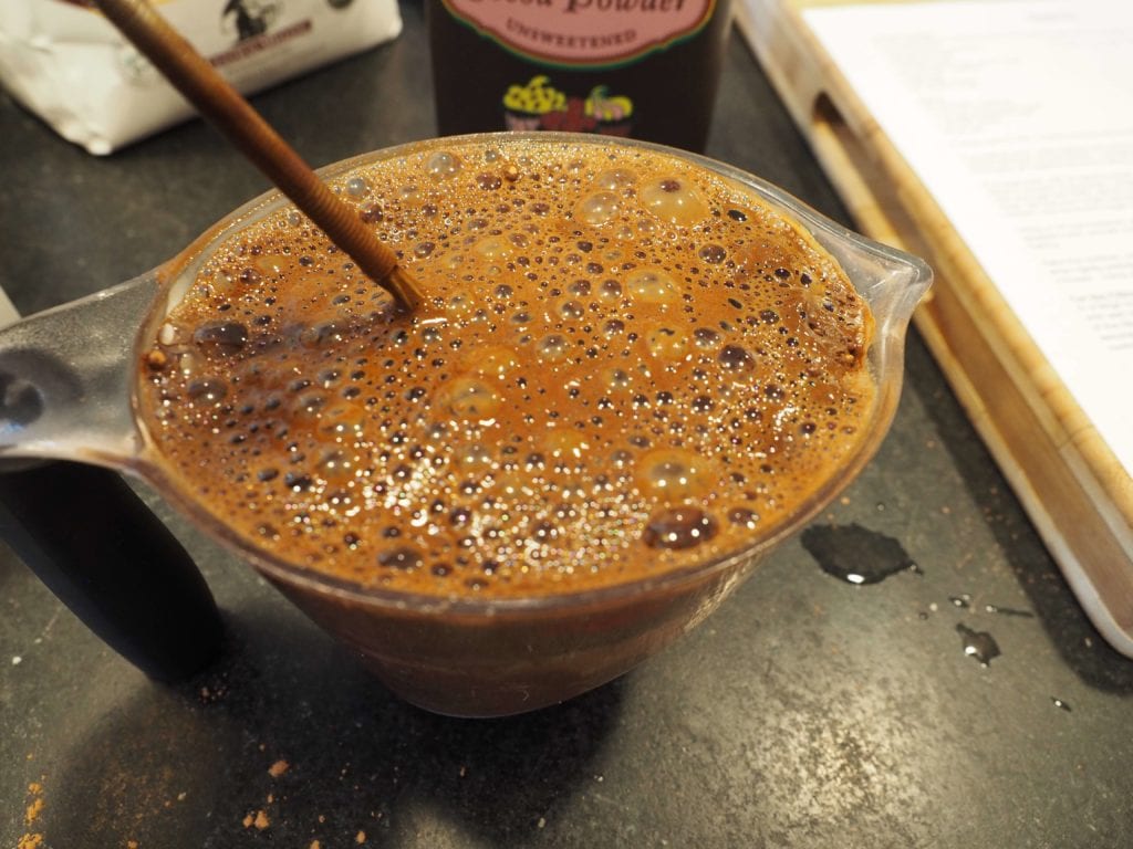 Foaming up hot water and cocoa in 2 cup measuring cup