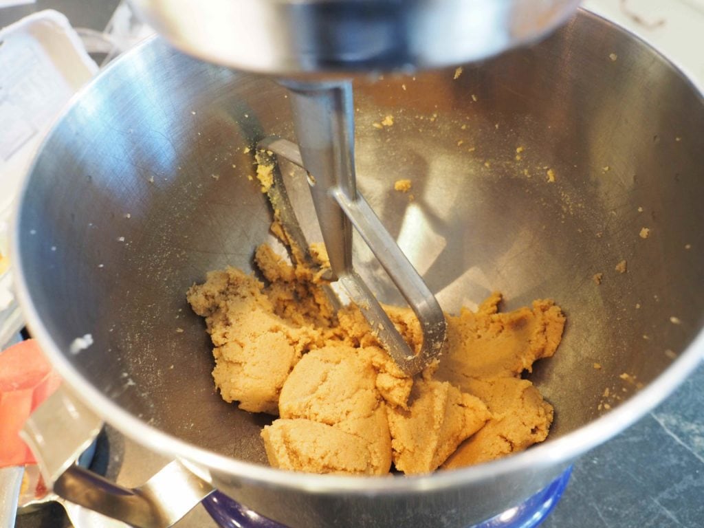 Mixer with basic batter, butter and brown sugar in mixing bowl
