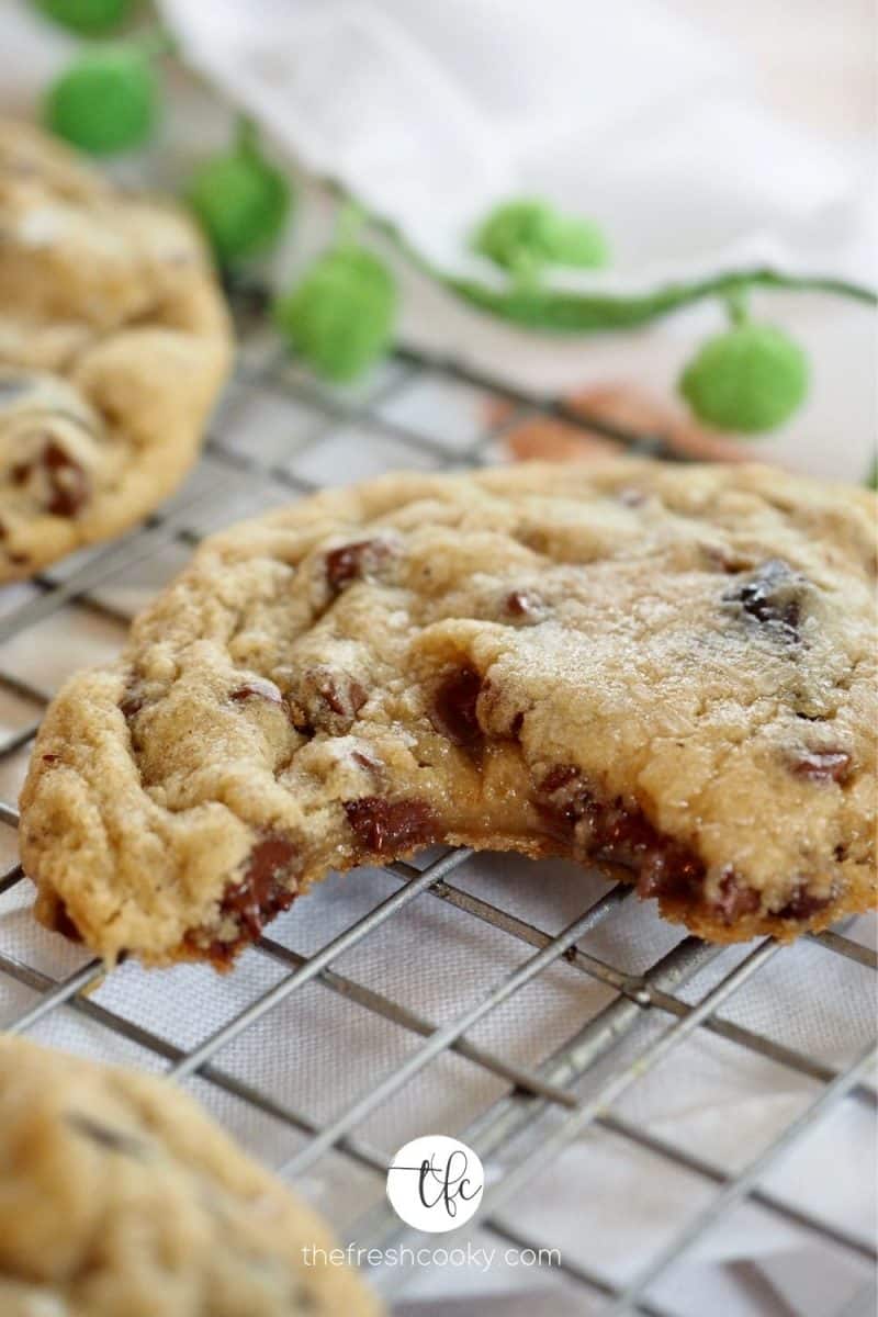 Chewy Gooey Chocolate Chip Cookie broken in half with gooey center showing.