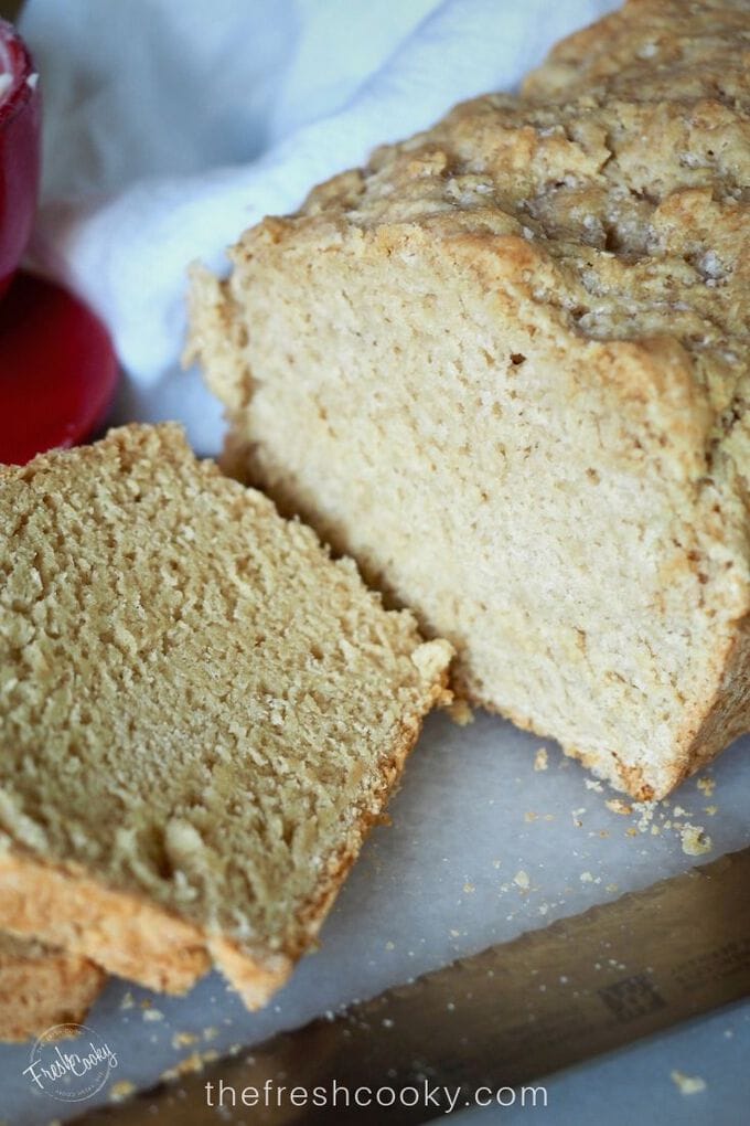 Close up image of sliced beer bread with loaf and a few slices.