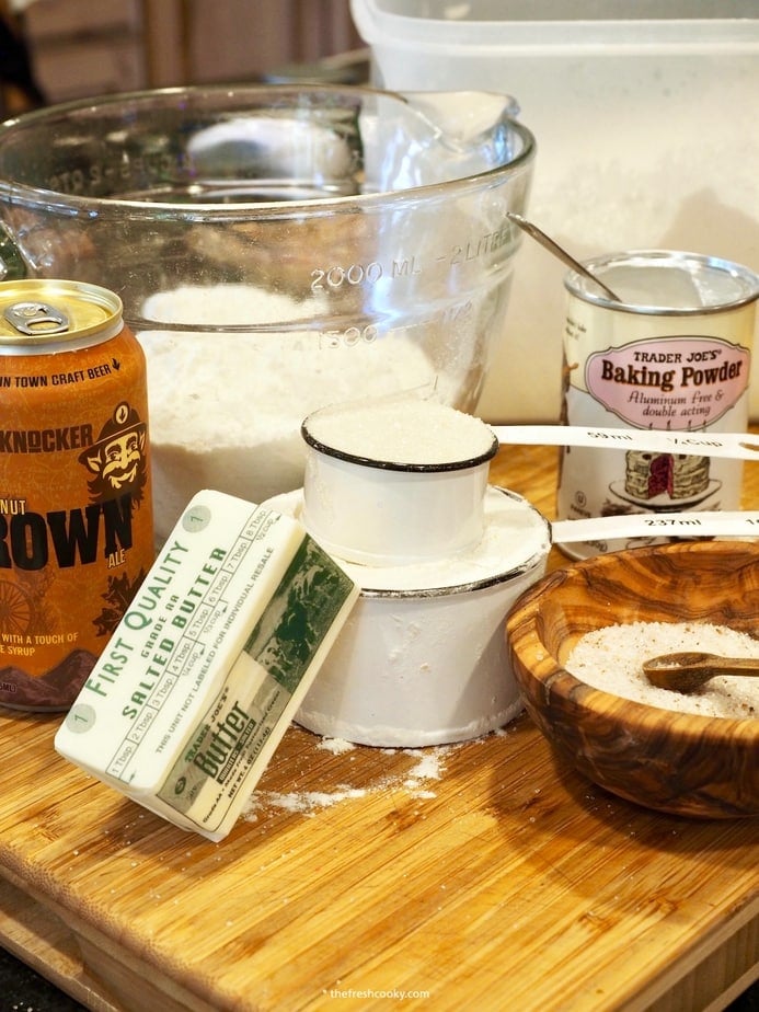Ingredients for Beer Bread. Left to right. Beer, Flour, baking powder, salt, sugar and butter.
