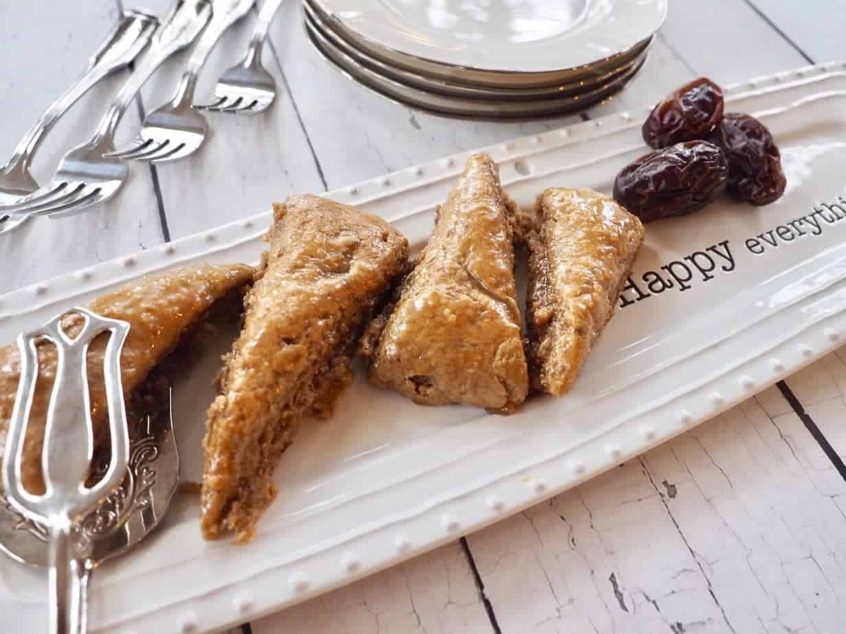 pretty plate of date scones with serving tool and fresh dates beside.