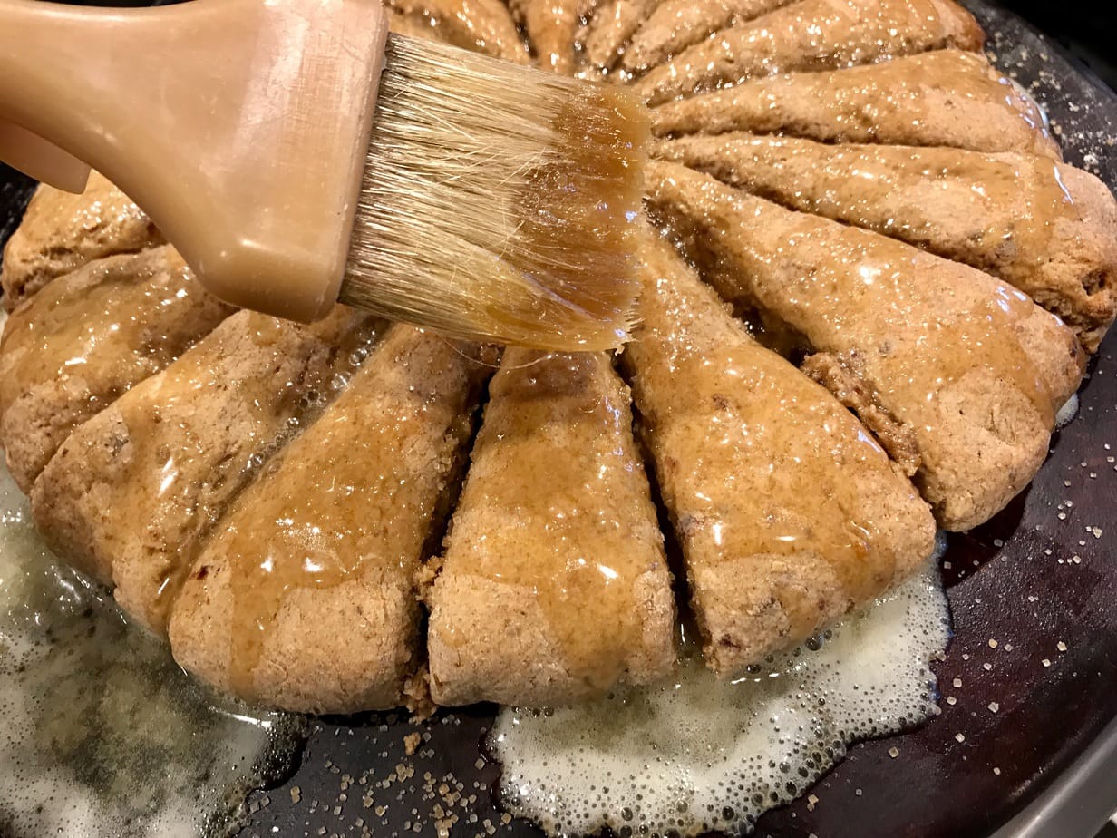 brushing on buttermilk glaze date scones.