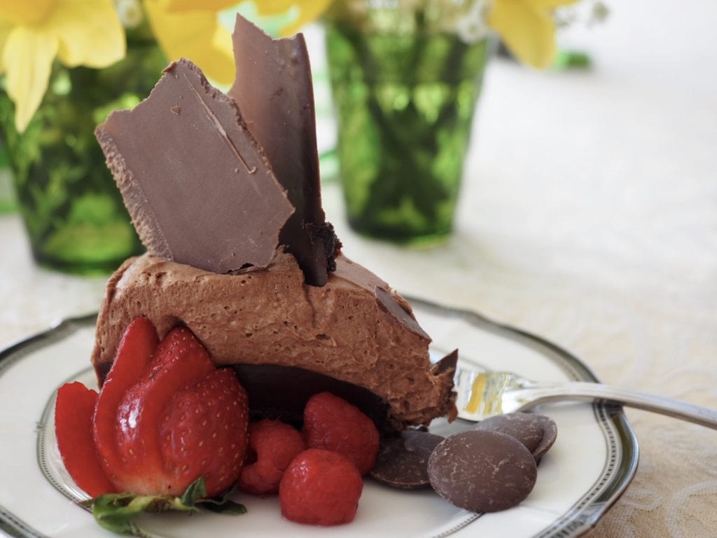 Triple Chocolate Layer Cake with a fudge brownie base, creamy, rich ganache center and a luscious and light cream cheese chocolate mousse on top, garnished with chocolate shards! #thefreshcooky #triplechocolatecake #deathbychocolate #threelayer #cakedecorating #torte #cake #chocolate