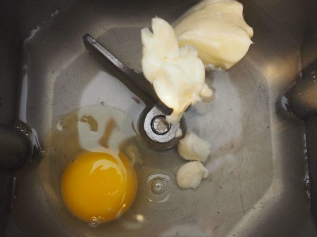 Water, butter and egg in bottom of bread machine pan.