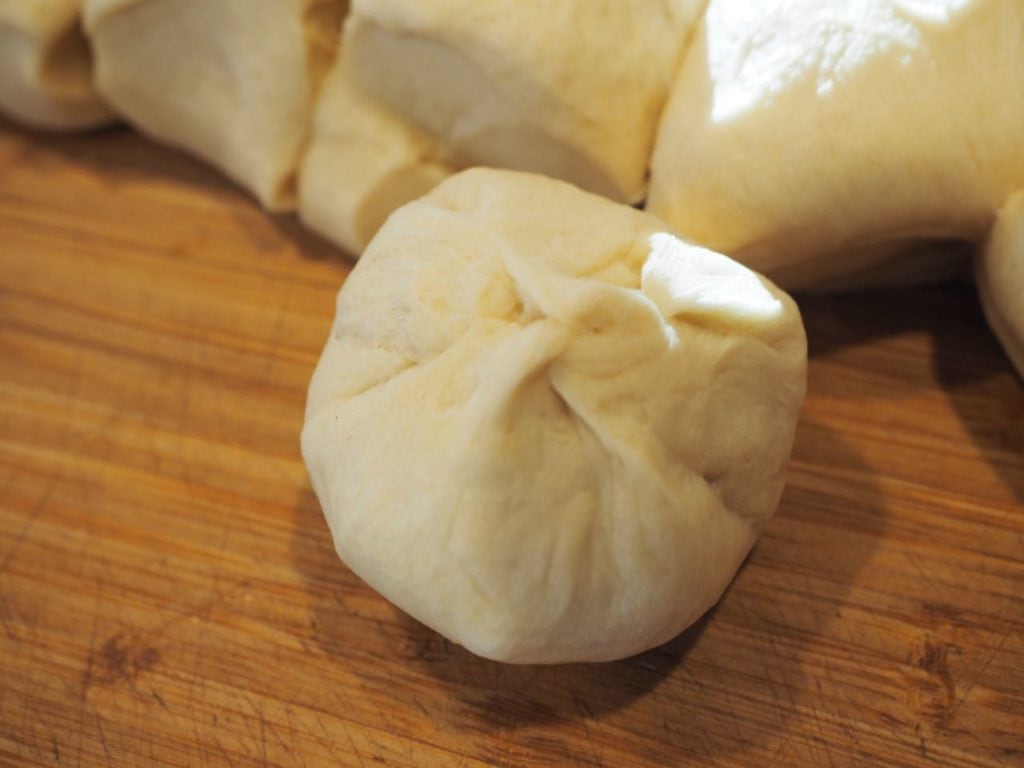 Finished underside, pinched together of easy yeast rolls. 