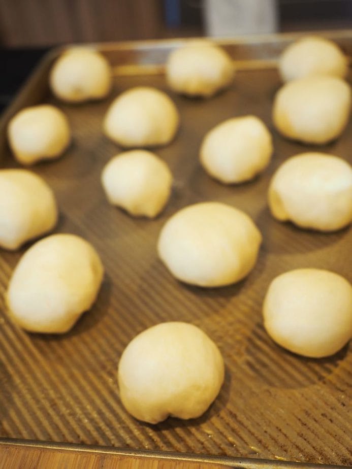 Yeast rolls on sprayed sheet pan, about 2 inches apart, ready to rise. 