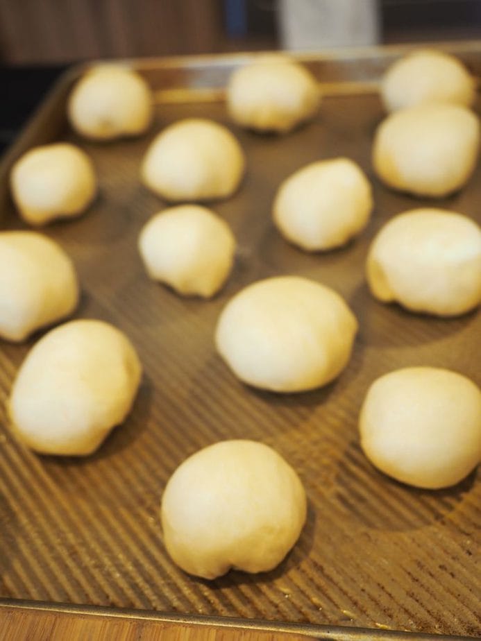 Yeast rolls on sprayed sheet pan, about 2 inches apart, ready to rise.