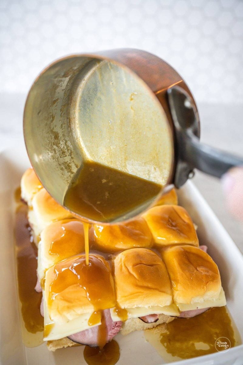 Pour sauce all over the tops and sides of the Hawaiian Rolls.