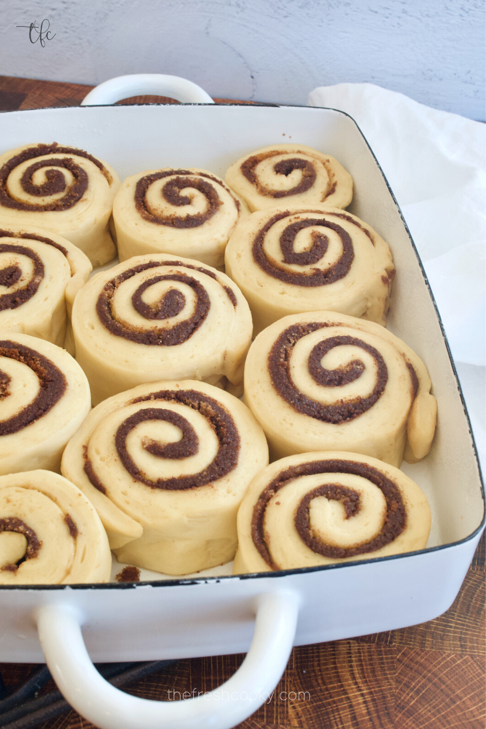 Cinnamon rolls before baking in pretty pan.