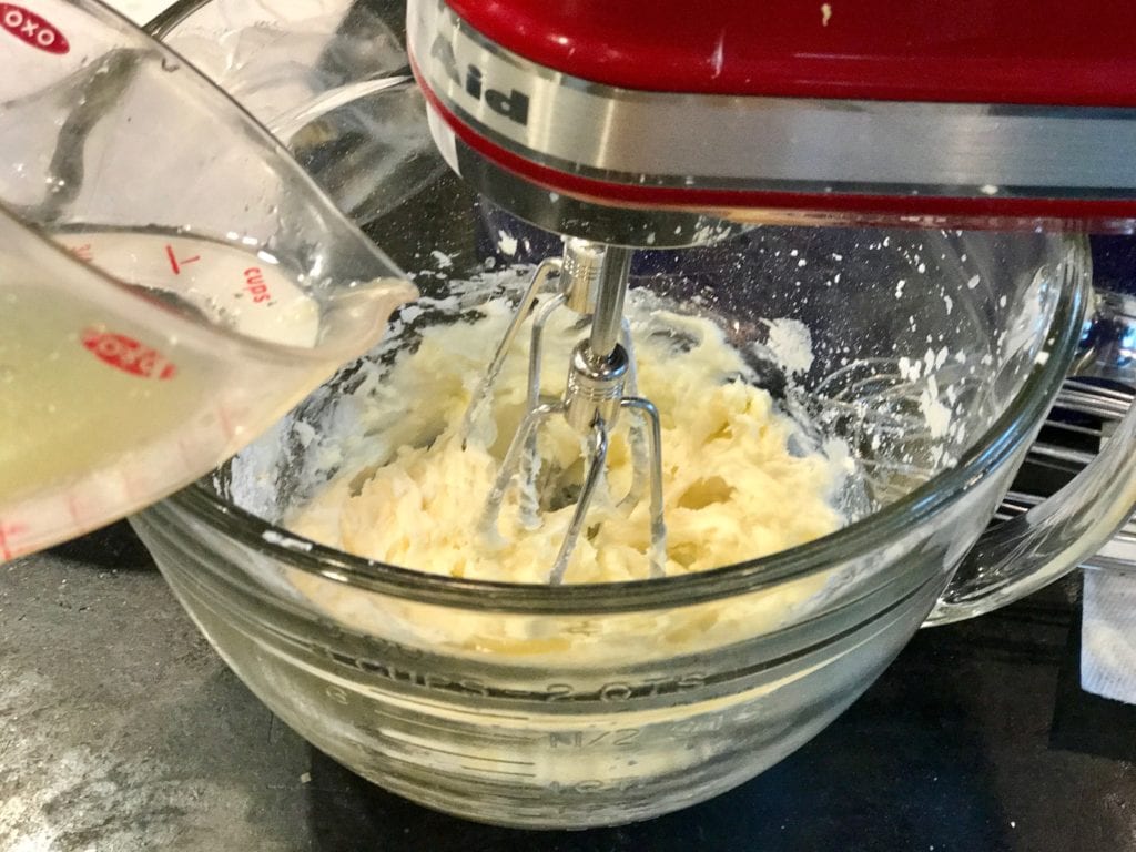adding lemon juice to butter, sugar mixture | www.thefreshcooky.com