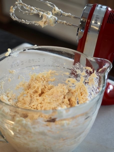 Hand mixer and mixing bowl with chicken and cheese mixture inside | www.thefreshcooky.com