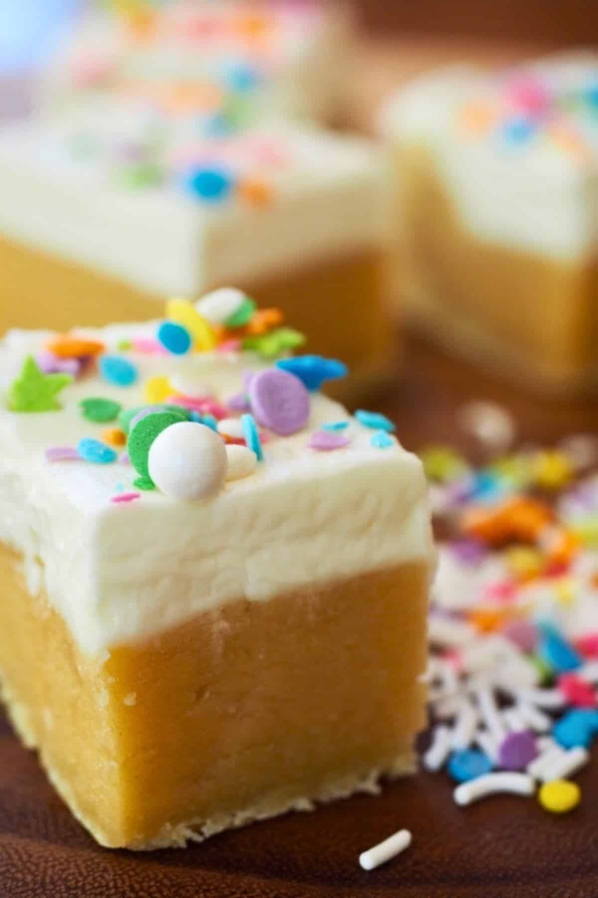 Super thick sugar cookie bars or bites with frosting and sprinkles. 