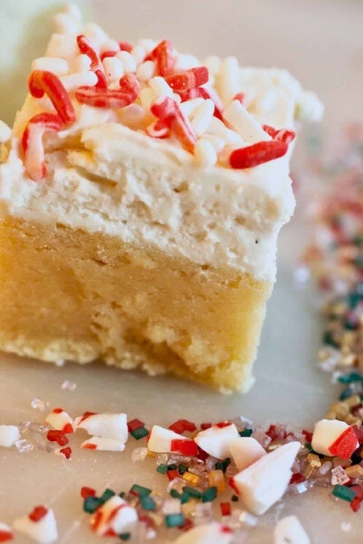 A soft thick, chewy, sugar cookie bar topped with a thick layer of frosting. 