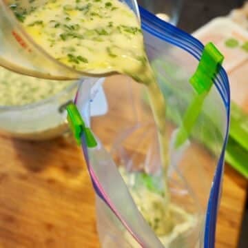 Pouring coconut lime marinade into baggie.