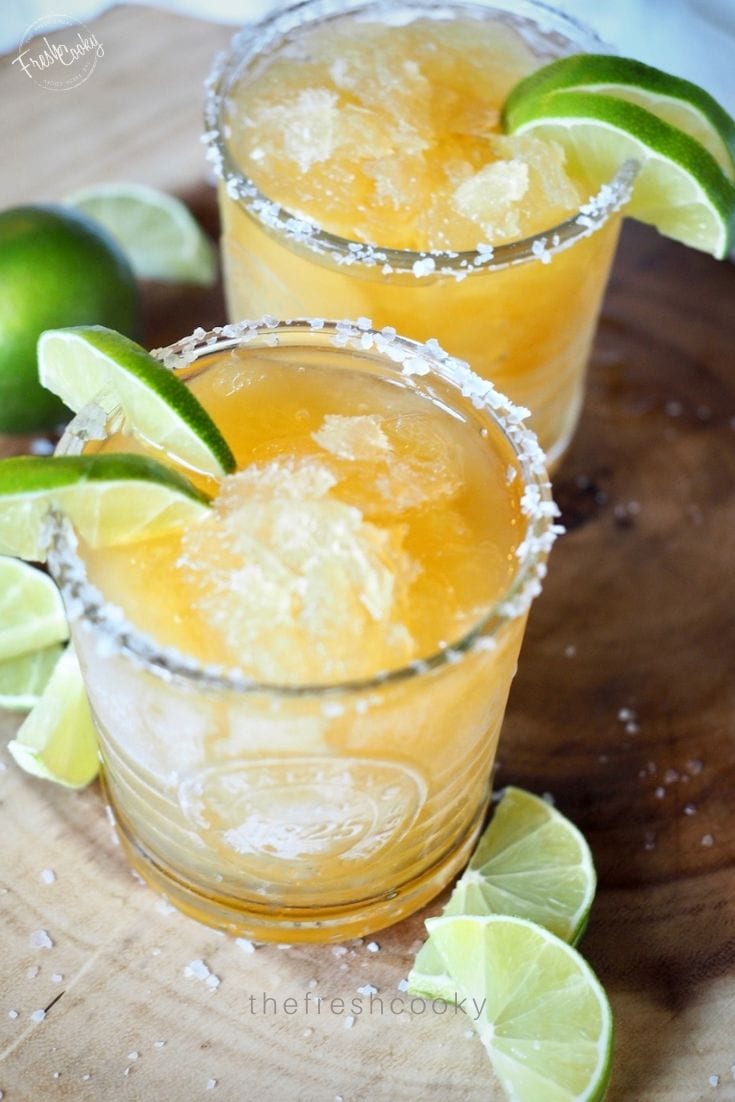 4-ingredient frozen margaritas with lime wedges. 