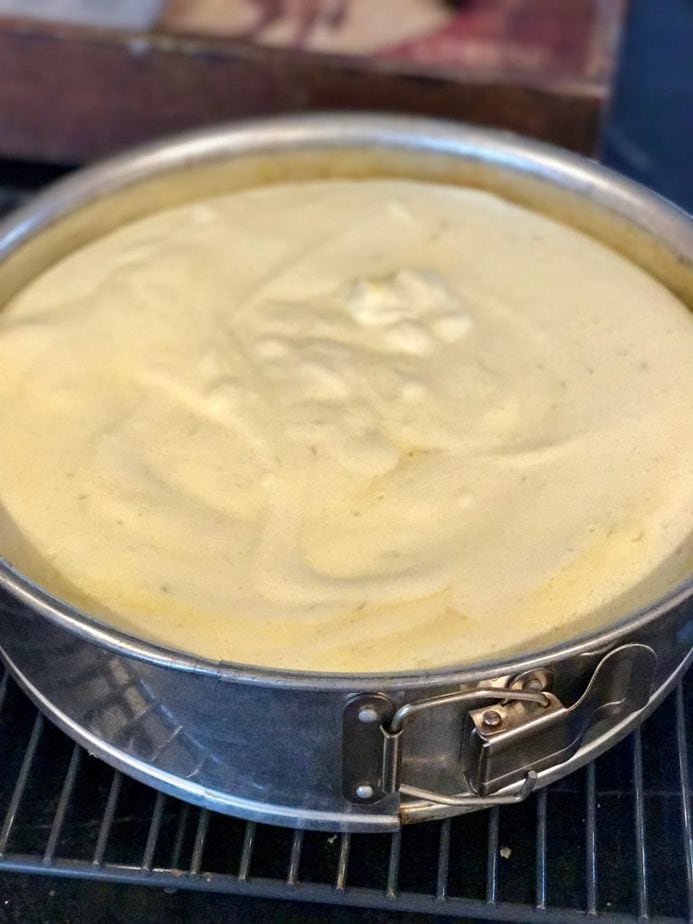 key lime torte in springform pan on cooling rack. 