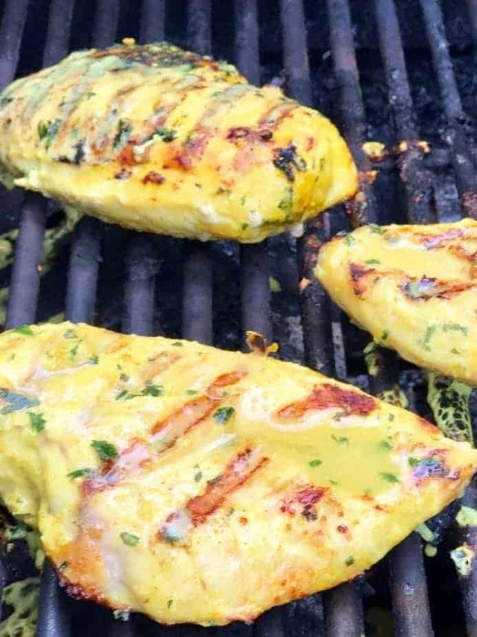 Thai coconut chicken with grill marks and a little marinade poured over while on grill.
