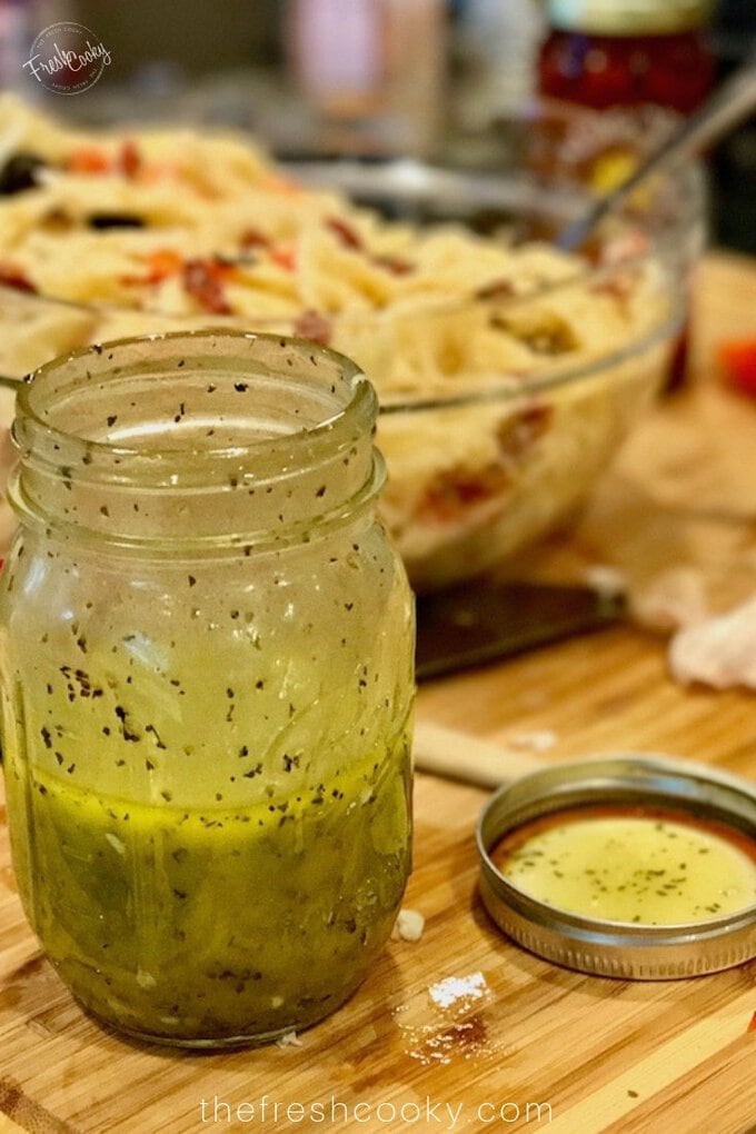 Shaken white balsamic vinaigrette in mason jar.