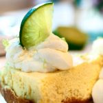 light and fluffy key lime torte on plate with whipped cream.