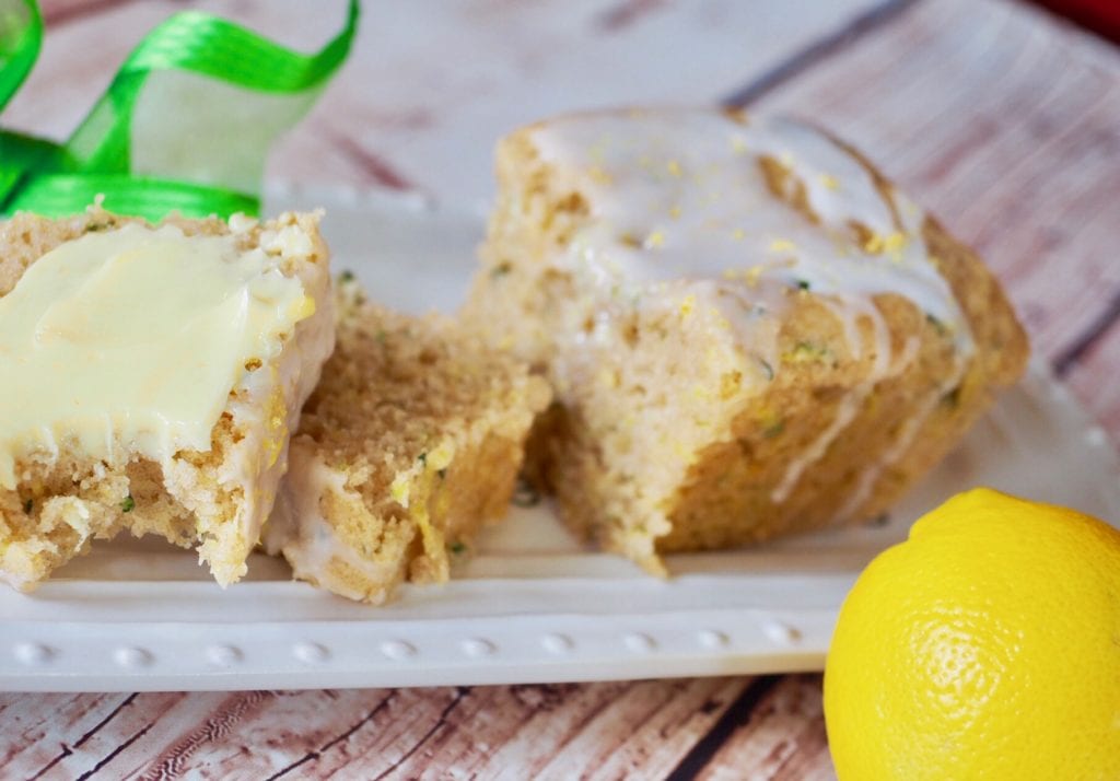 Lemon Zucchini Bread slices on plate with lemon and green ribbon in background. | www.thefreshcooky.com