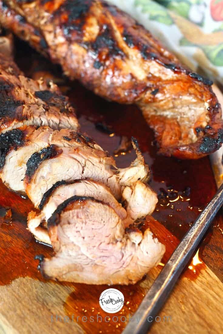 Simple pin for Asian pork marinated tenderloin with slices of juicy pork tenderloin on cutting board. 