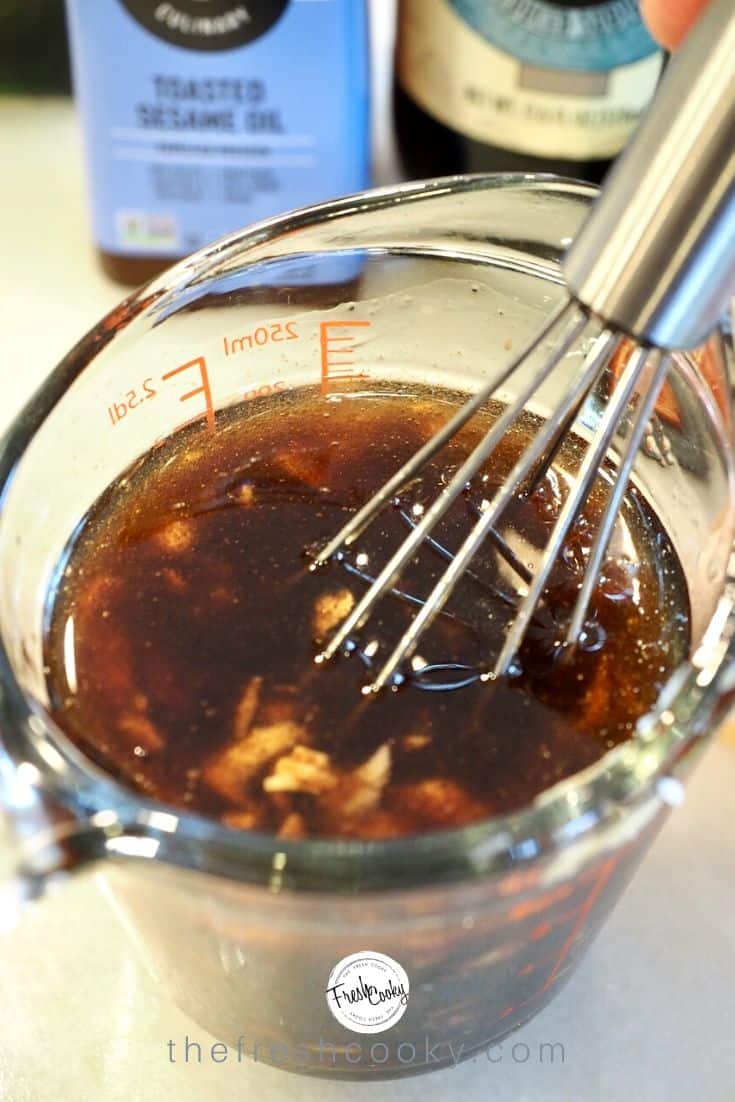Whisking together the quick Asian marinade.