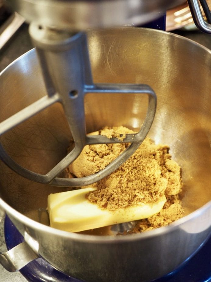 Stand mixer bowl with dark brown sugar and butter in mixer for Moist Pumpkin Bread.