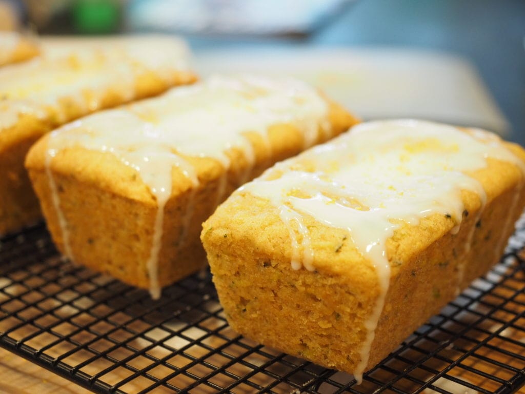 Mini Loaves of Lemon Zucchini Quickbread sitting on a cooling rack with drizzle of glaze over the tops | www.thefreshcooky.com