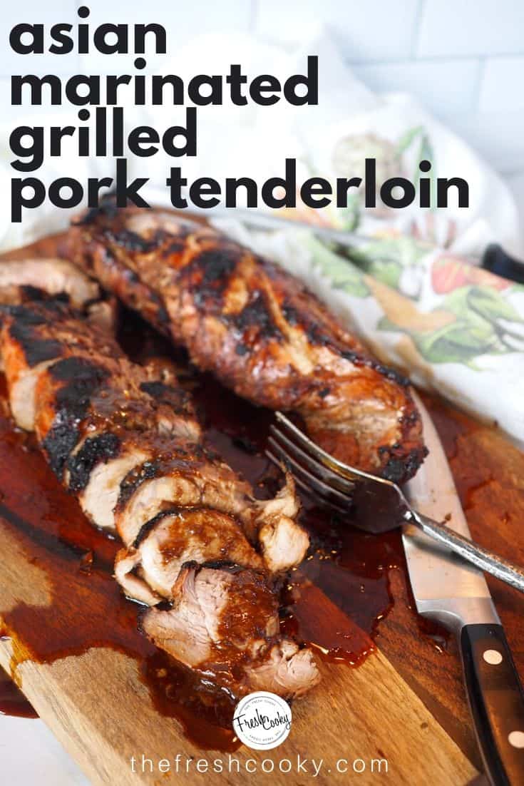 Asian marinated grilled pork tenderloin pin with juicy sliced pieces of tenderloin on a cutting board. 