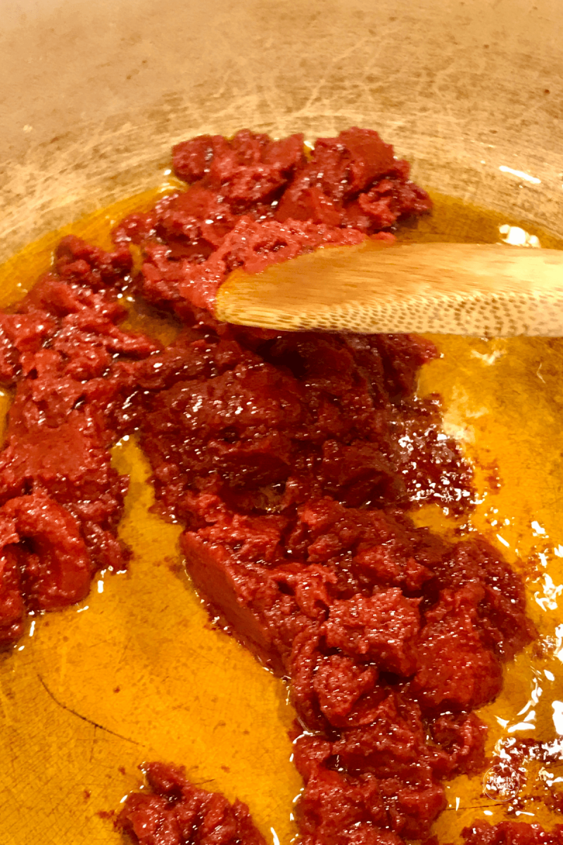 Browning tomato paste in olive oil with garlic.