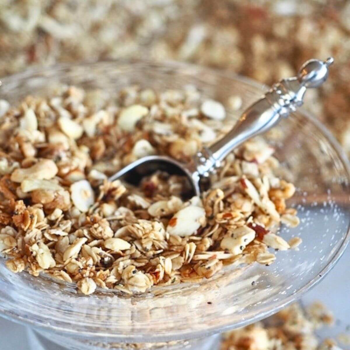 Crock pot granola, a soft and chewy granola in a bowl with a scoop.