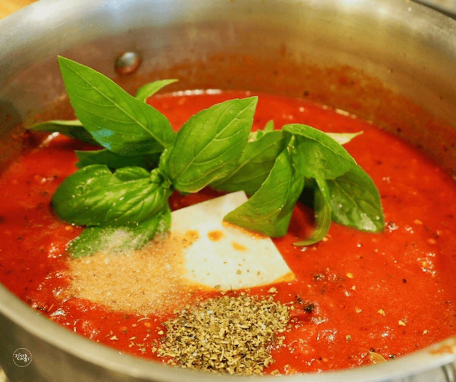 Spices and fresh basil in spaghetti sauce. 