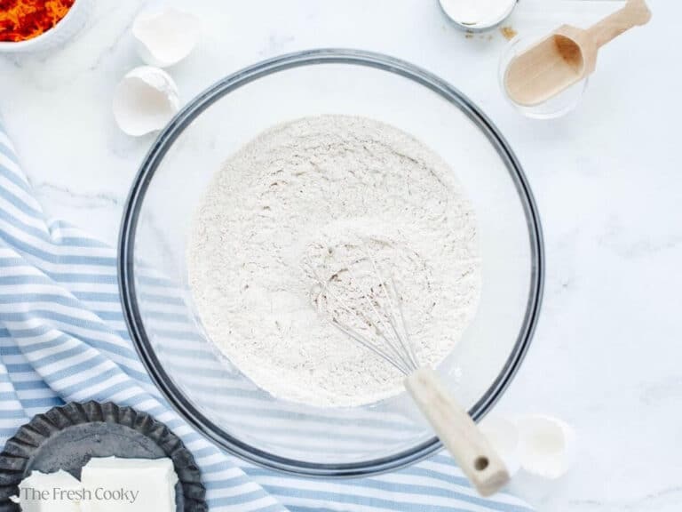 In a medium bowl, flour and whisk are mixing dry ingredients. 