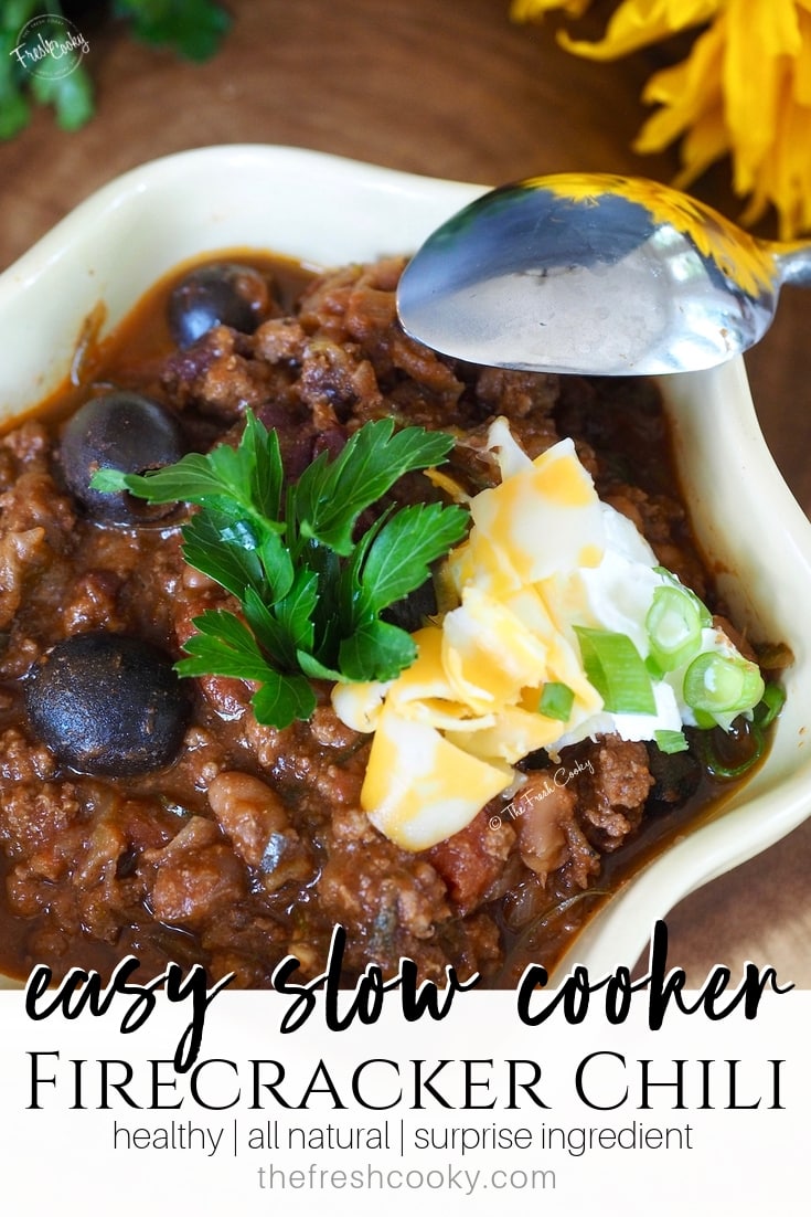 Close up pin for pinterest of beef chili with olives, sour cream and cheese. Recipe on www.thefreshcooky.com