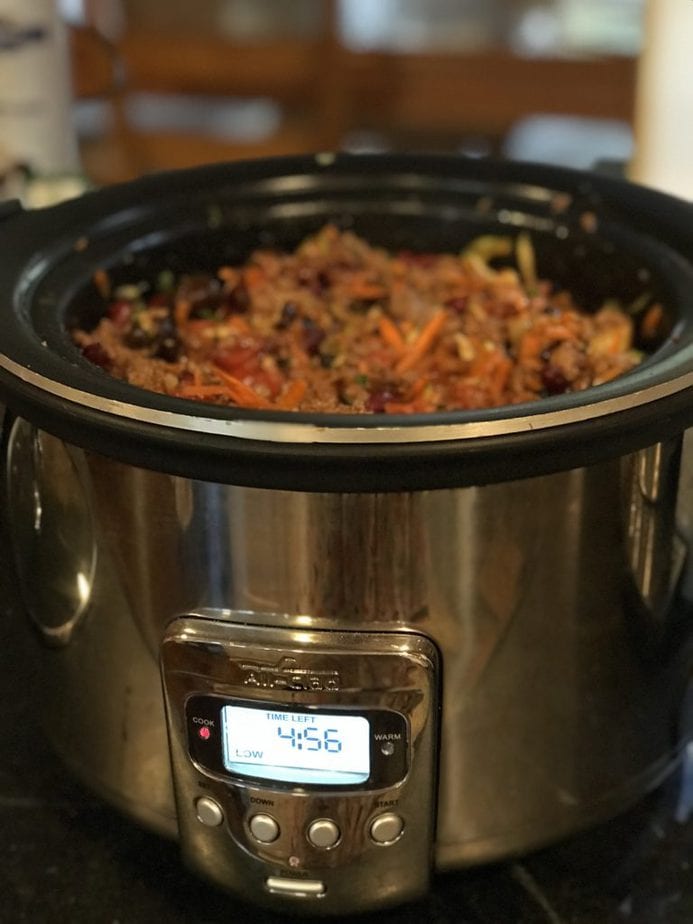 Slow cooker showing time left cooking at 4:56 for Firecracker Chili recipe. 
