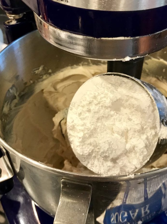 pouring in powdered sugar for brown sugar frosting | www.thefreshcooky,com