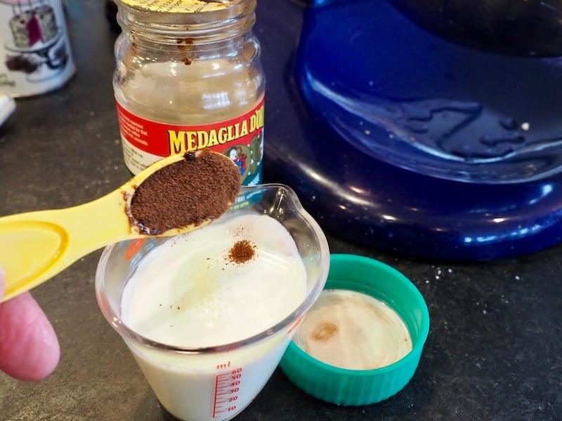 Cream and espresso powder in measuring cup