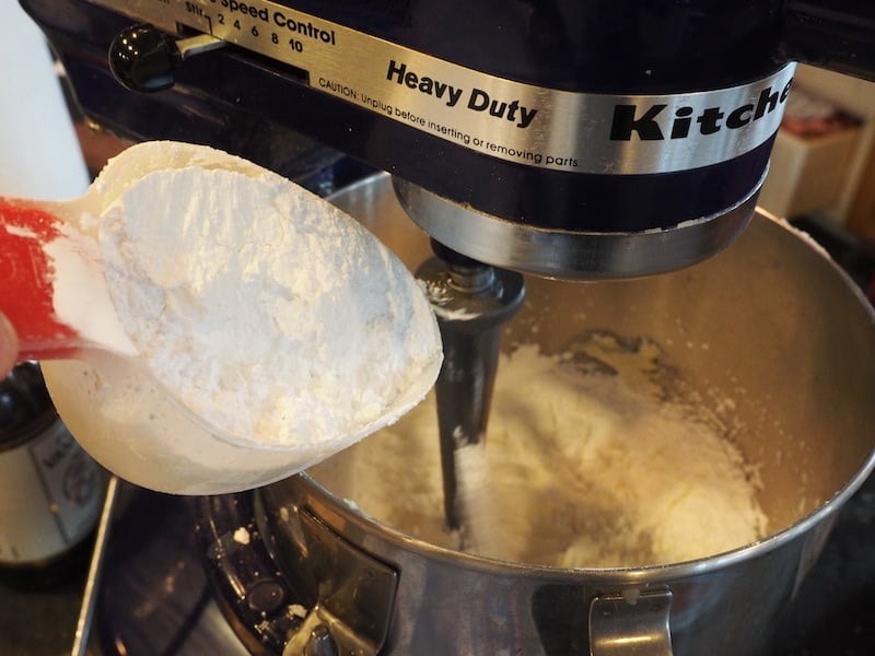Adding powdered sugar to butter and kahlua mixture. 