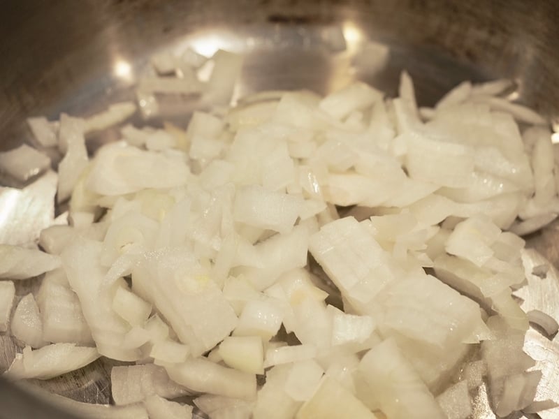 chopped white onion in a saucepan.