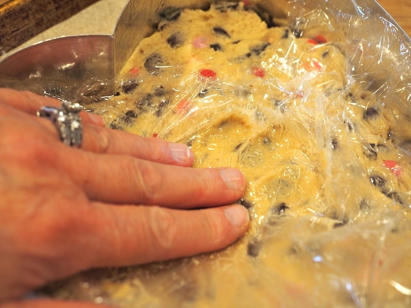 Using plastic wrap to push cookie dough into heart shaped pan. 