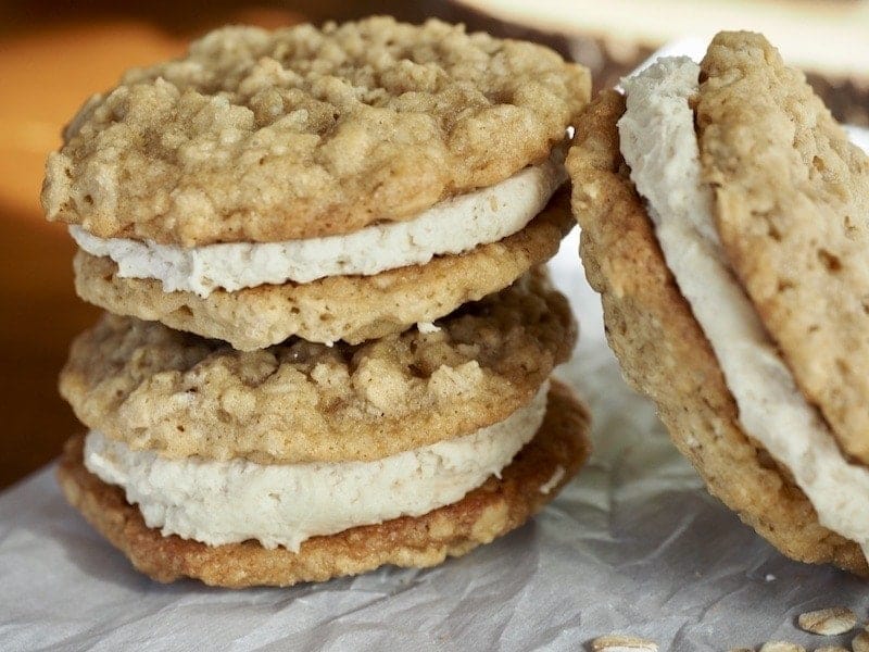 INCREDIBLE Oatmeal Sandwich Cookie recipe from thefreshcooky.com these are much better than any storebought cookie, like a handheld bowl of oatmeal! Soft, chewy, with the salty deliciousness of oats with this amazing maple, brown sugar buttercream sandwiched between. Click through for the how-to! #oatmealsandwichcookies #sandwichcookies #oatmeal #cookies #dessertrecipes #lunchboxideas #oatmealcreampie