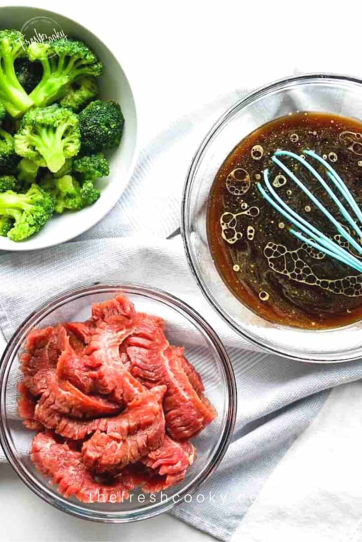 ingredient shot for easy beef and broccoli with broccoli florets, sauce and beef in a bowl.
