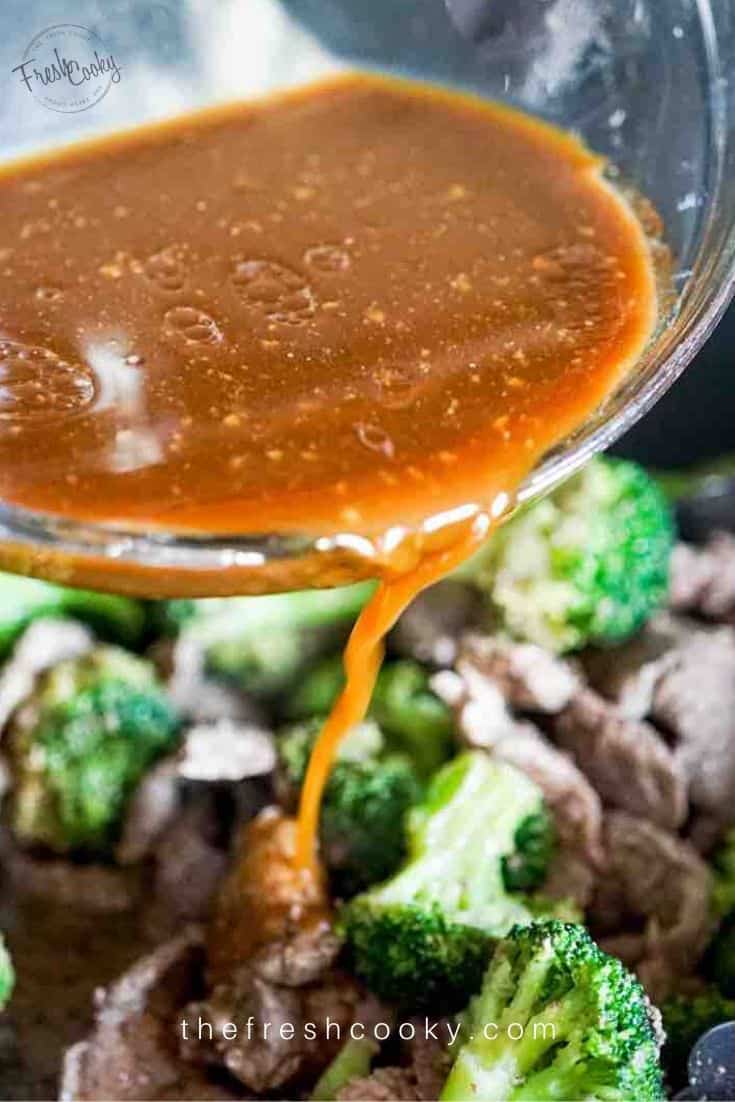 pouring sauce onto beef and broccoli.