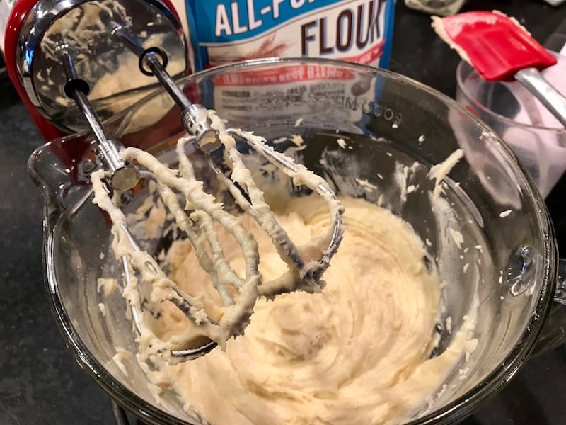 Mixed batter for blueberry crumb cake in mixing bowl with beaters.