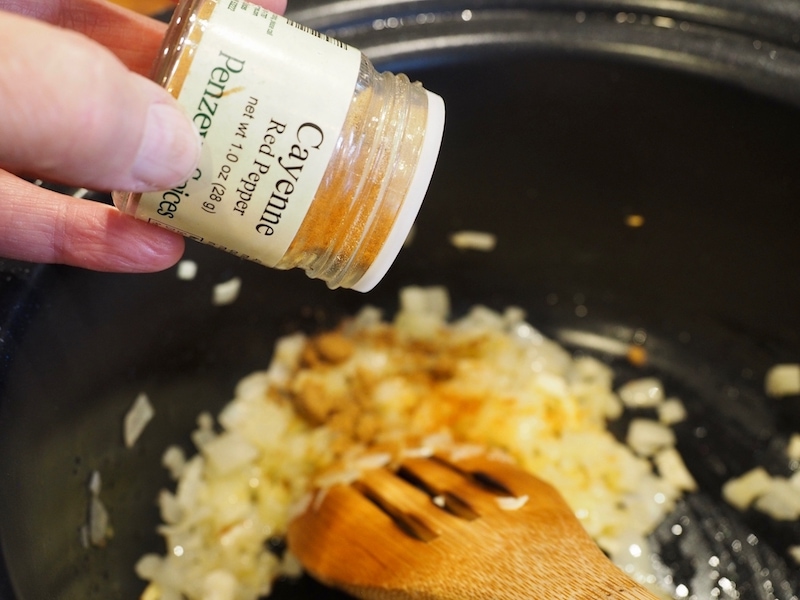 Sprinkle of cayenne pepper going into crockpot