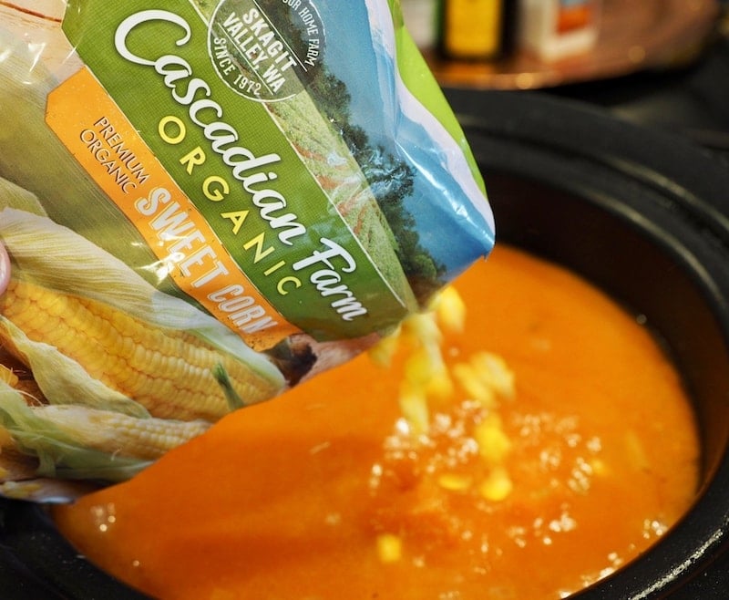 Bag of cascadian farm organic sweet corn being poured into crockpot. thefreshcooky.com 