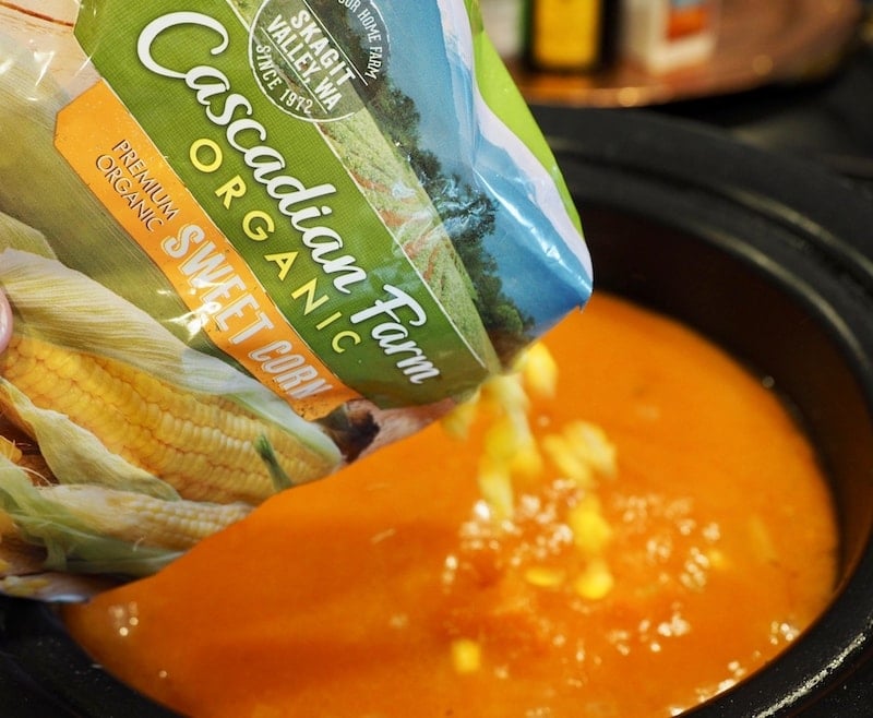 Bag of cascadian farm organic sweet corn being poured into crockpot. thefreshcooky.com