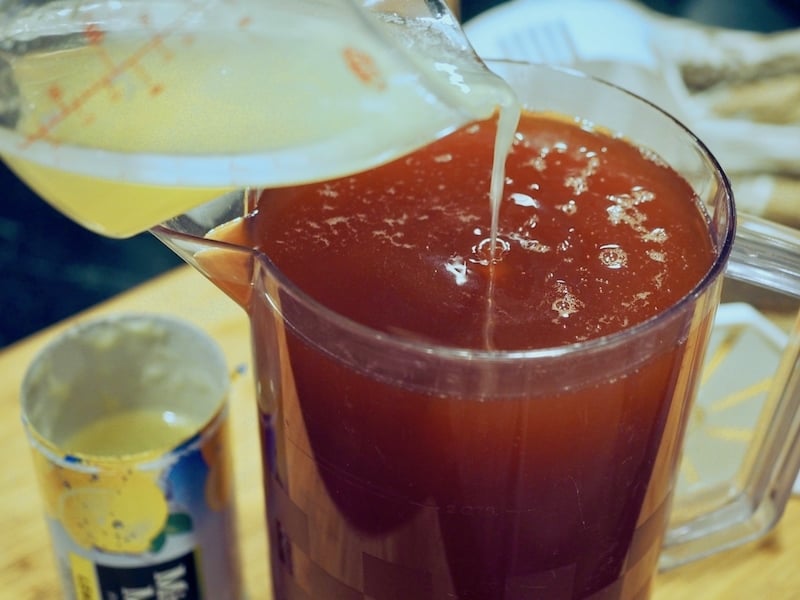 Pouring in thawed lemonade concentrate. 