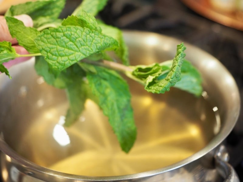 Adding fresh mint to simple syrup for Texas Tea. 